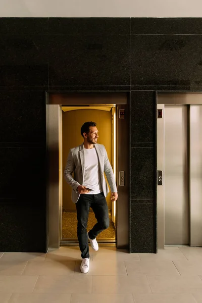 young businessman leaving the elevator in a finance building. bu