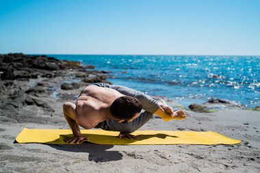 Genç Yogi Adam cennette yoga yapıyor.