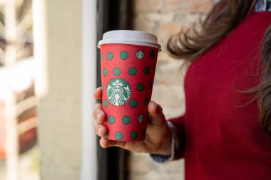 New York, Usa - 5 Aralık 2019: Sokakta uzun bir Noel Starbucks kahvesi tutan bir kadına yakın çekim.