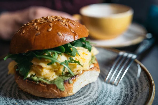 Veggie burger with poached egg and sorrel in a curd bun. healthy breakfast concept in the style of a lifestyle.