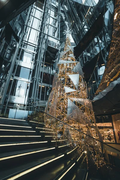 Vista de uma árvore de Natal iluminada dentro de um moderno centro comercial no distrito financeiro de Londres — Fotografia de Stock