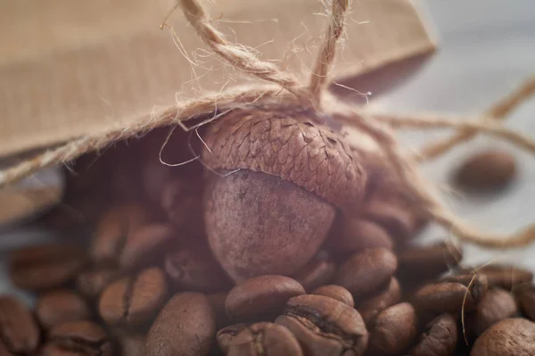 Dried acorn, coffee beans, jute cord, brown paper bag — Stock Photo, Image