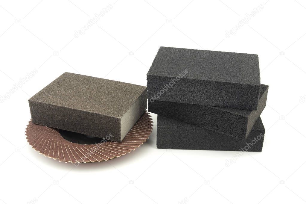 Set of different tools for grinding - flap disc for angle grinder and abrasive sponges , isolated on white background