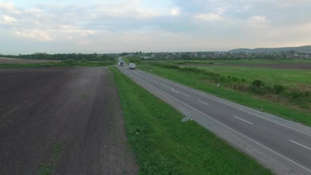 トラックの運転の道路 benween フィールドの空中ショット. — ストック動画