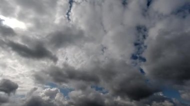 Zaman aşımı: Güneş gökyüzünde uçuşan kabarık bulutların ardında saklı.