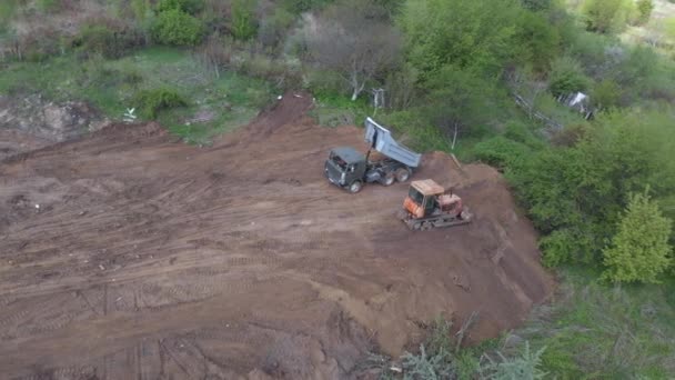 Plano aéreo del volquete que descarga el terreno en el sitio de construcción adicional . — Vídeo de stock