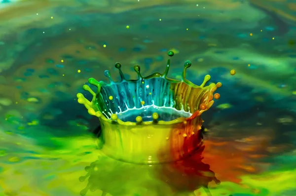 Bursts of multi-colored bright colors of paint in the form of crowns and colorful splashes