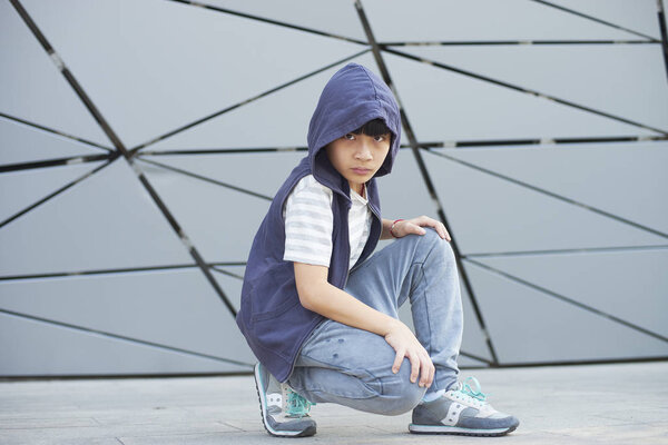 portrait of cool Asian kid posing outdoors