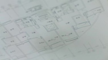closeup silhouette of fingers pointg on blueprint when discussing