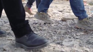 close-up of feet walking on gravel slow motion