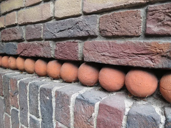 Brick wall with red balls — Stock Photo, Image