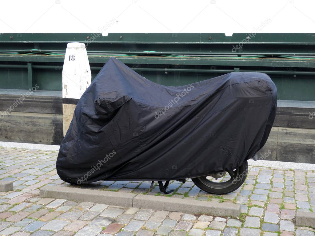 covered motorbike on a quay in Dordrecht