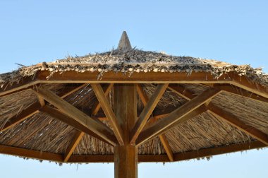 Mavi gökyüzü arka plan üzerinde güneş koruyucu şemsiye