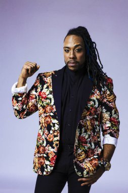 Çiçek desenli bir takım elbise giyen bir adamın stüdyo portresi.