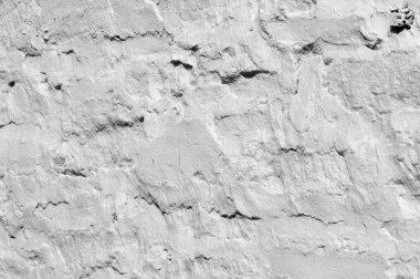 Doku, desen, arka plan. beyaz boya ile badanalı taş kaplı bir duvar