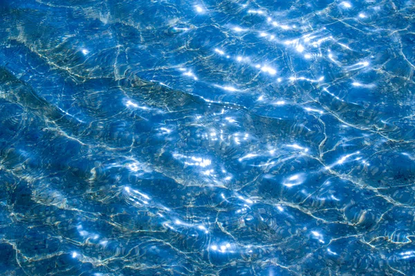 テクスチャ背景 プールの水はカウンター光で撮影します 波に太陽のまぶしさから — ストック写真