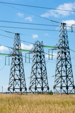 Elektrik pilon mavi gökyüzü karşı detay: yüksek gerilim elektrik direği aşağıdan