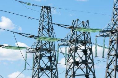 Elektrik pilon mavi gökyüzü karşı detay: yüksek gerilim elektrik direği aşağıdan