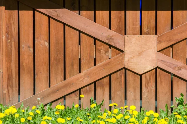 Wooden fence. a barrier, railing, or other upright structure, typically of wood or wire, enclosing an area of ground to mark a boundary, control access, or prevent escape.