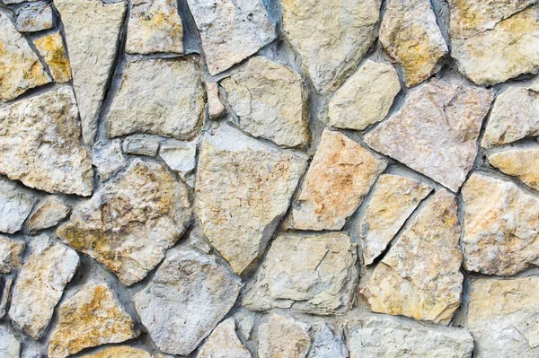 Textura, fondo. Antecedentes Muralla de piedra salvaje forrada. Sandston. — Foto de Stock