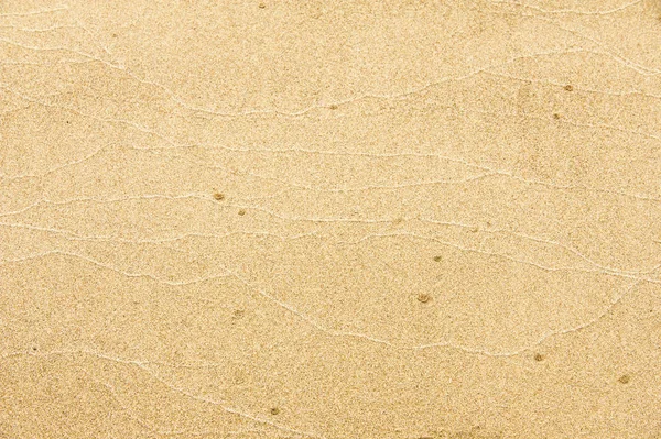 Textura, fondo. la arena en la playa. sustrato granular suelto — Foto de Stock