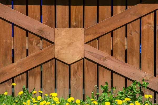 Wooden fence. a barrier, railing, or other upright structure, typically of wood or wire, enclosing an area of ground to mark a boundary, control access, or prevent escape.