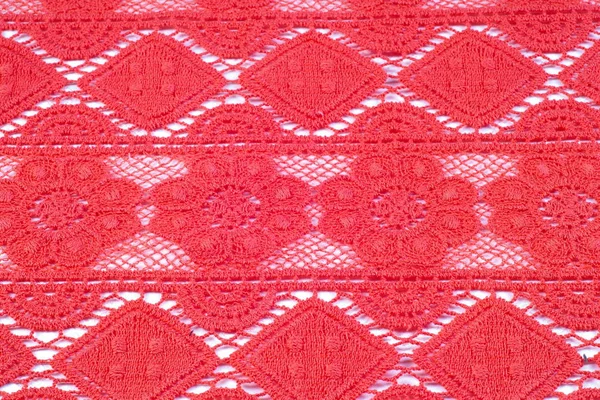 Červené krajkové textilie textura fotografie v ateliéru — Stock fotografie