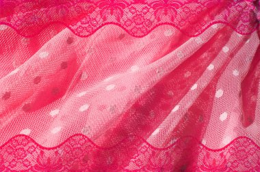The texture of fabric lace with sequins on fabric background. a small, shiny disk sewn as one of many onto clothing for decoration. Magenta, Hot pink, Cerise clipart