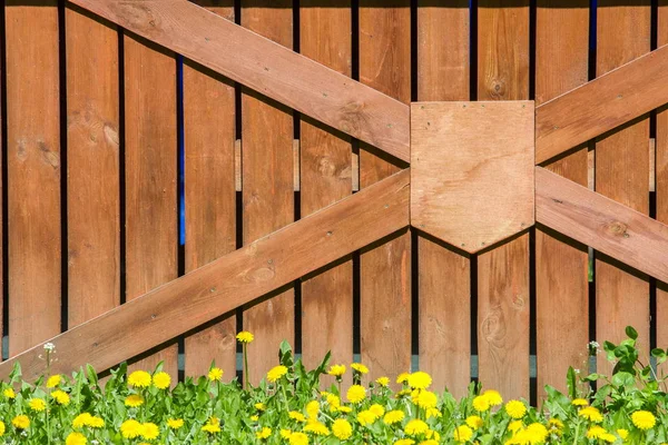 Wooden fence. a barrier, railing, or other upright structure, typically of wood or wire, enclosing an area of ground to mark a boundary, control access, or prevent escape.