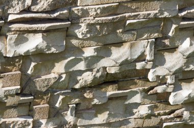 Kusursuz doku, arka plan, granit duvarlarla kaplı taş. Kum taşı. Taş zemin duvarı. Yüzleşen Taş