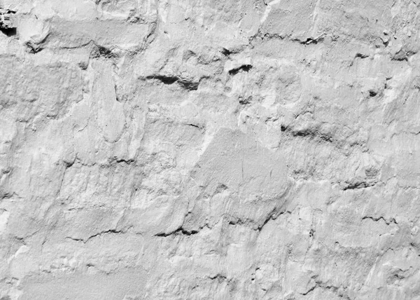 Doku, desen, arka plan. beyaz boya ile badanalı taş kaplı bir duvar