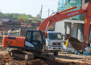 Naberezhnye Chelny, Tatarstan, Russia, Excavators digging the pit. construction, building, development, constructing.  clipart