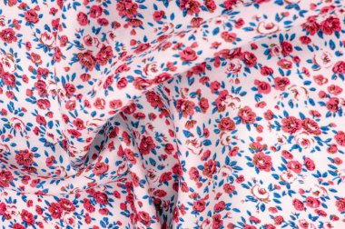 Arka plan doku, küçük kırmızı çiçekli ince pamuklu kumaş. Orta ağırlıkta, kapitone bez veya kumaş pamuk kumaş küçük yaz çiçek, pembe, mor, sarı, yeşil yapraklar, beyaz arka plan üzerinde