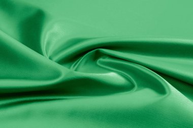Doku, arka plan, desen. Yeşil ipek kumaş dokusu. Güzel zümrüt yeşil yumuşak ipek kumaş.