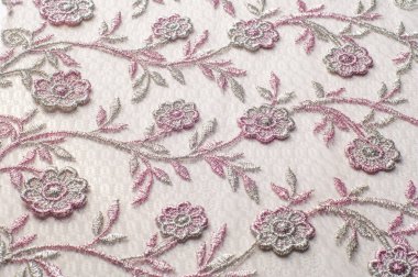 Doku, arka plan, desen. Pembe dantel çiçek üzerinde beyaz bir arka plan ile dekore edilmiştir. Arka planını çiçekler ile dekore edilmiş pembe dantel kumaş