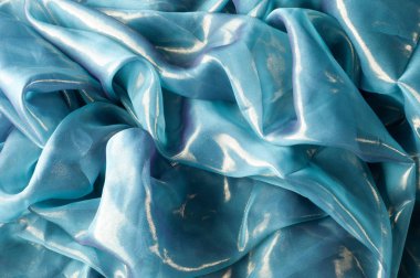 Doku, arka plan, desen. İpek kumaş mavi, ince havadar ipek kumaş, kumaş güneş ışınlarının yansıtır.