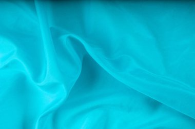 Doku arka planını kumaş. Mavi kumaş, aqua, mavi, Bondi mavi, gök mavisi, mavi mavi, pembe yumurta mavi, Skobelov, Turkuaz, çiçek adları ipek. İpek veya saten yumuşak zarif mavi bir arka plan olarak kullanılabilir