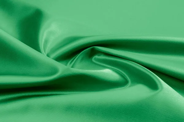 Doku, arka plan, desen. Yeşil ipek kumaş dokusu. Güzel zümrüt yeşil yumuşak ipek kumaş.