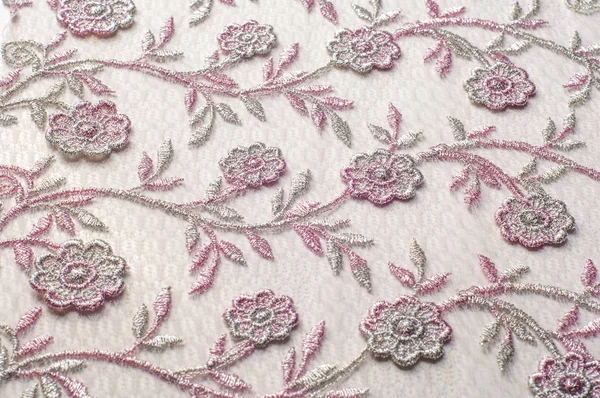 Doku, arka plan, desen. Pembe dantel çiçek üzerinde beyaz bir arka plan ile dekore edilmiştir. Arka planını çiçekler ile dekore edilmiş pembe dantel kumaş