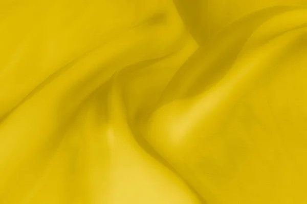 Texture, background, pattern. Yellow transparent silk fabric. Sunshine Yellow Silk Charmeuse Satin,