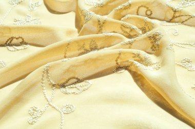 Doku, arka plan, desen. Kadın renk şal. Altın Başak. Limon kremalı. Navajo beyazdır. Eski altın. ipek kumaş.