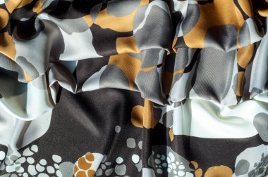 Doku, arka plan, desen. Soyut desen bir ipek kumaş, beyaz sarı kahverengi halkaları