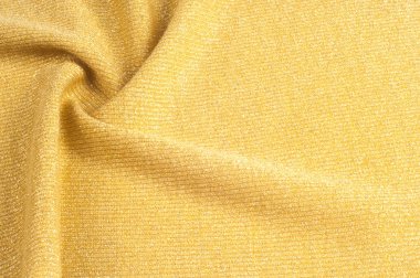 Doku, arka plan, desen. Altın bir ton kumaş. Bronz Sha