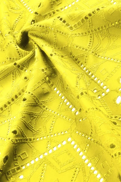 Texture, motif. Le tissu est jaune dense avec des trous perforés. P — Photo