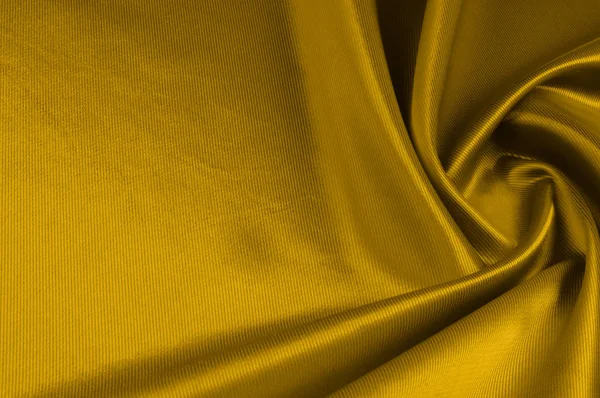 Текстура, фон, рисунок. Желтый атлас шелковая ткань . — стоковое фото