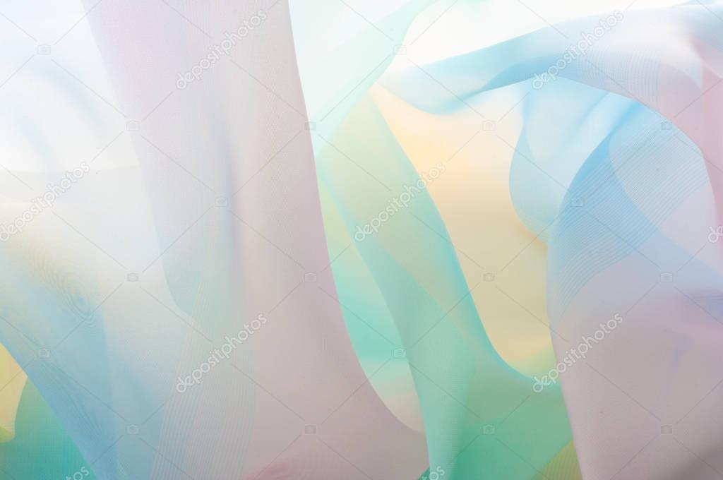 Texture, background, pattern. Silk fabric is transparent, yellow