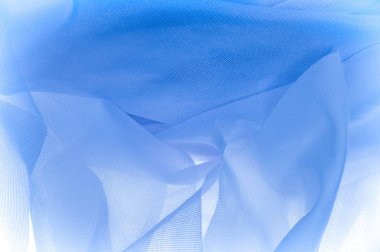 Doku, arka plan, ipek kumaş dokusuna mavidir. İpek kumaş saydamdır. Kumaş ya da sıvı illüstrasyon ipek saten doku veya kadife malzeme dalgalı kırışıklıklar dalga veya lüks mavi