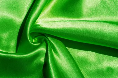 Doku, kumaş, arka plan. Lüks kumaş ya da sıvı dalgalar ya da dalgalı kırışık ipek saten doku kadife malzeme ya da lüks Noel ya da zarif arka plan arka plan. Yeşil