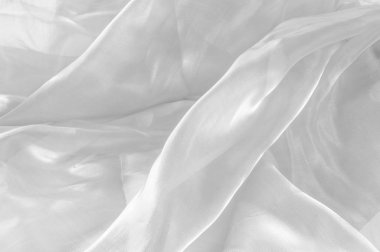 Arka plan doku, desen. Kumaş beyazdır. Beyaz ipek kumaş arka plan narin ve zarif. Parlak saten kumaş, katlanmış bir arka plan olarak kullanmak için. Kumaş Tekstil yüzey üst türü. 