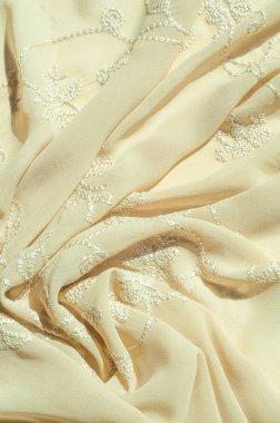 Doku, arka plan, desen. Kadın renk şal. Altın Başak. Limon kremalı. Navajo beyazdır. Eski altın. ipek kumaş.